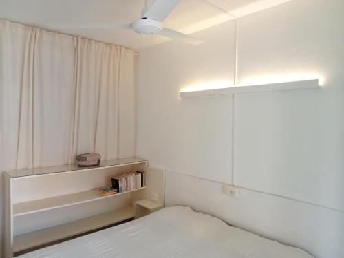 a small bedroom with a bed and a window at Canova Apartment in Santa Maria