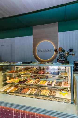 a display case filled with lots of different pastries at Fun & Sun Club Saphire in Tekirova