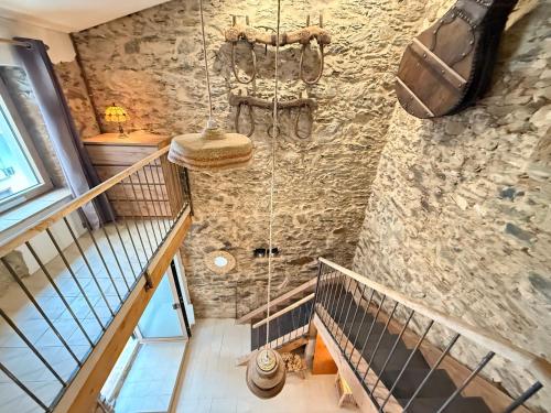 a staircase in a house with a stone wall at Agi Porthos Apartments in Roses