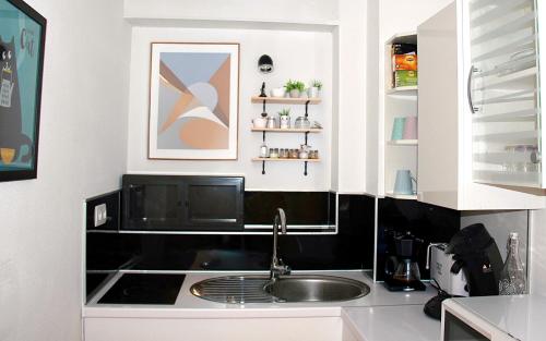 a kitchen with a sink and a counter at La Colombière - Vue imprenable sur l'Ardèche - Très Calme - Très bien situé - Résidence Privée in Montélimar