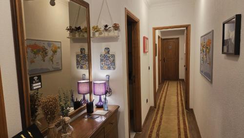 a hallway with a mirror and a dresser and a hallway with a hallway istg at Guest House da Mata2 in Póvoa de Varzim