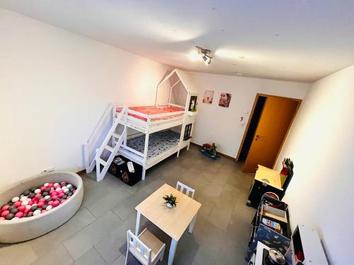 a room with a bed and a tub in a room at Kinderparadies Alt Lüxem in Wittlich