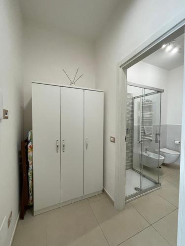 a bathroom with white cabinets and a toilet at CASA VACANZE CASANOVA in Agerola