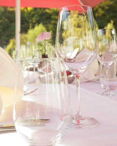 a group of wine glasses sitting on a table at Parkhotel Idar-Oberstein in Idar-Oberstein