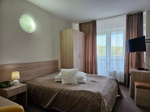 Postel nebo postele na pokoji v ubytování Hotel Mures