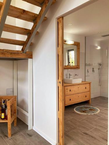 a bathroom with a sink and a mirror at Vila Harmónia in Lúčka