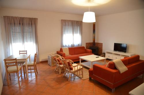 a living room with a couch and a table at Pro Touristic Casa Montejunto in Pereiro