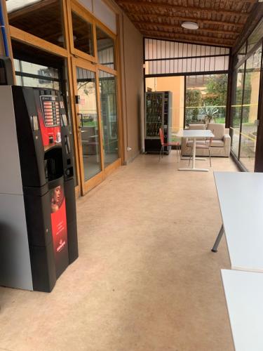 an empty lobby with a vending machine in a building at Poncinvs Residence in Bergamo
