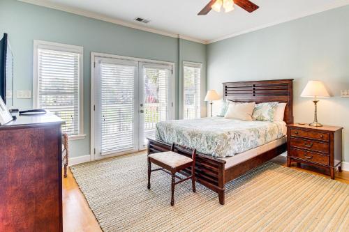 a bedroom with a bed and a dresser and windows at Tybee Island Gem: Spacious Home w/ Private Pool in Tybee Island
