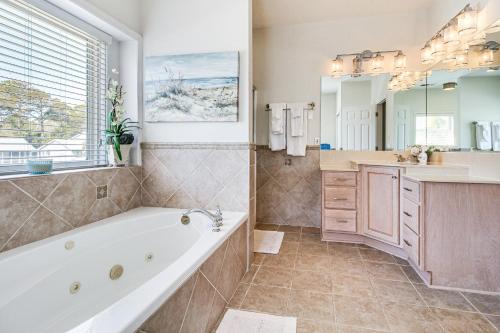 a large bathroom with a tub and a sink at Tybee Island Gem: Spacious Home w/ Private Pool in Tybee Island