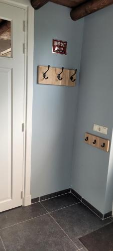 a room with a wall with akeep out sign on it at Wellness bungalow met privésauna en hot tub - Glamping aan de Maas in Kessel