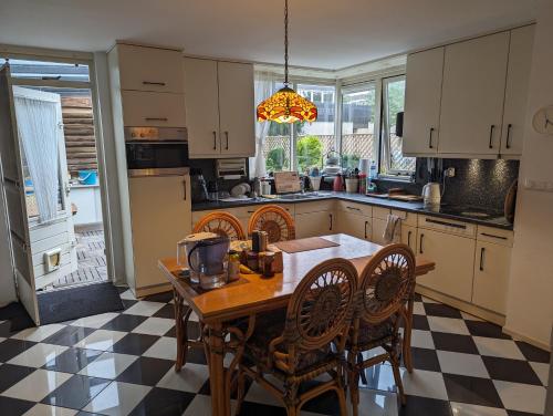 a kitchen with a wooden table and chairs and a table at Volendam in Volendam