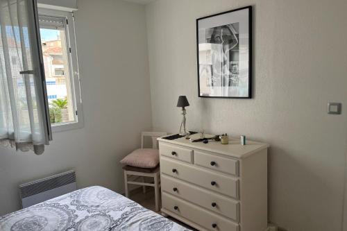 une chambre avec un lit, une commode et une fenêtre dans l'établissement The squadra with swimming pool, à Frontignan