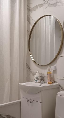 a bathroom with a sink and a mirror at Aura, City Center, Tartu Home in Tartu