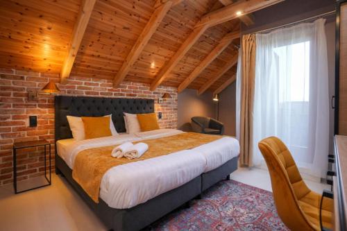 a bedroom with a large bed with a dog laying on it at ChaChaCha House Vendégház in Egerszalók