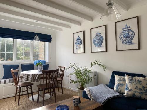 a living room with blue and white vases on the wall at Garden Flat in West Lulworth in West Lulworth