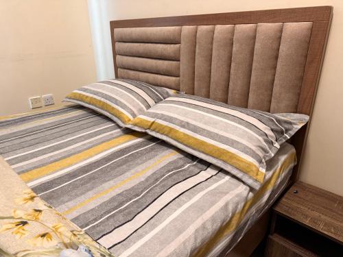 a bed with two pillows on top of it at Premium Furnished studio in Sharjah