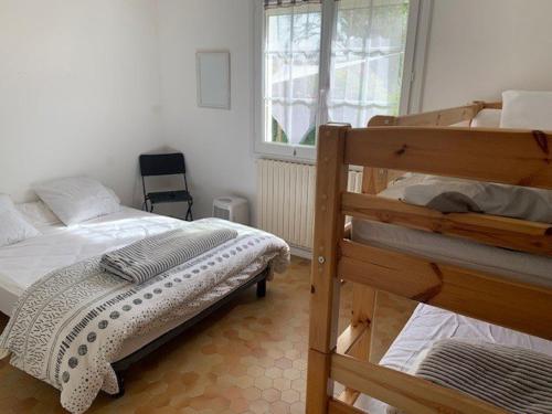 une chambre avec deux lits superposés et une fenêtre dans l'établissement Les Grandes Fauvettes - Saint Hilaire de Riez, à La Parée Preneau