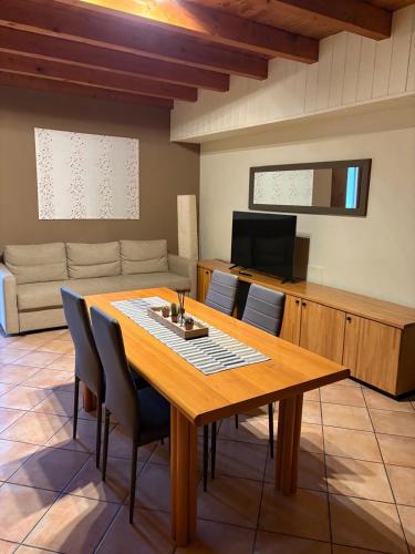 a dining room with a table and a couch at Poncinvs Residence in Bergamo