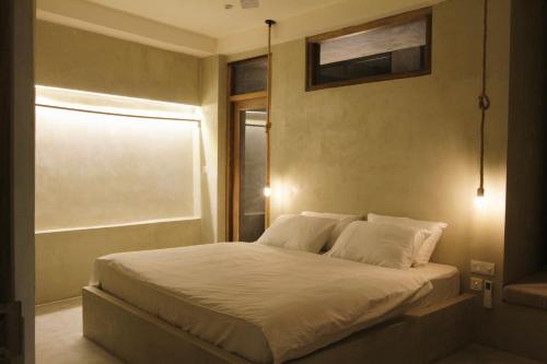 a bedroom with a white bed with a window at Dannys Madiha in Godakanda