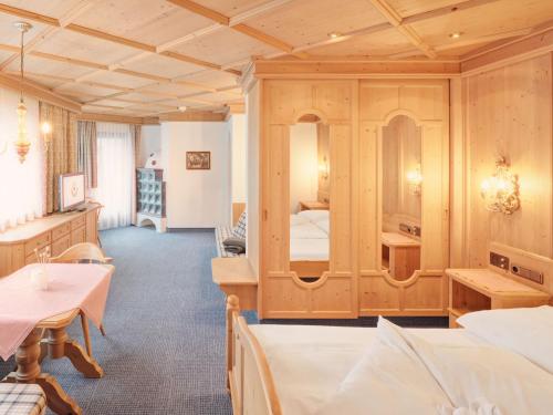 a hotel room with two beds and a bedroom at Hotel Magdalena Mayrhofen in Mayrhofen
