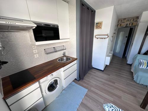 une cuisine avec un évier et une machine à laver dans l'établissement BEAU STUDIO Climatisé en bord de Mer et Wi-Fi, au Grau-du-Roi