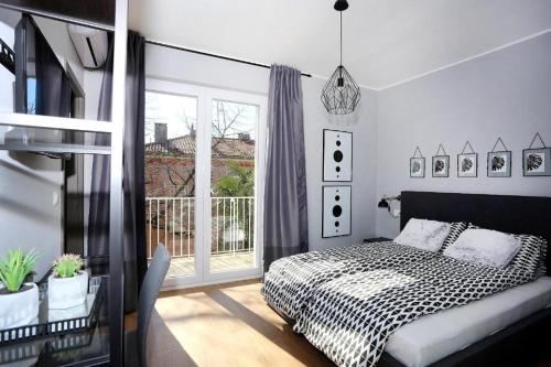 a bedroom with a bed and a window at Prestige design rooms in Zadar