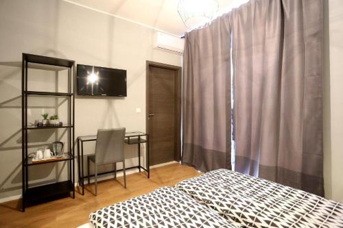 a bedroom with a bed and a table and a desk at Prestige design rooms in Zadar