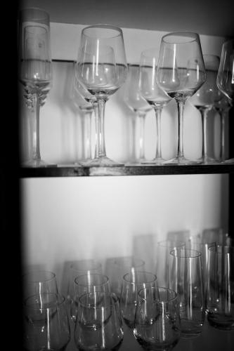 a bunch of wine glasses sitting on shelves at Eliá Dendró Víla in Lydenburg