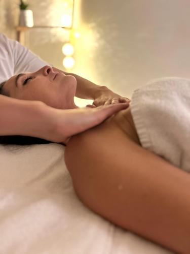 a woman laying on a bed with her panties on at La Lune De Mougins - Hotel & Spa in Mougins