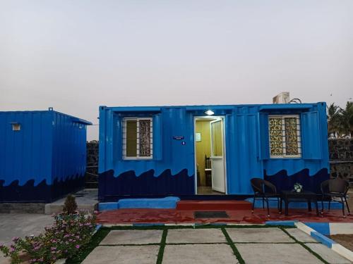 a blue house with a table in front of it at Chan Beach Resort & Hotel in Bahūr