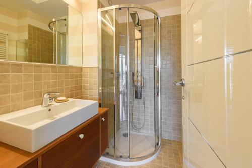 a bathroom with a sink and a shower at Golden Luxe - Panoramic Penthouse Rooftop whit Pool in Lido di Camaiore