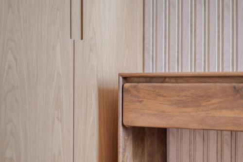a close up of a wooden door next to a wooden wall at Amazing 1BDR New Building by Blue Cloud Holidays in Sharjah Intl
