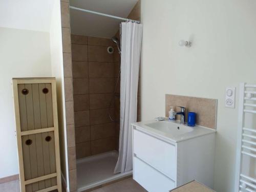 a small bathroom with a sink and a shower at Javeline Saint Hilaire de Riez in Sion-sur-lʼOcéan