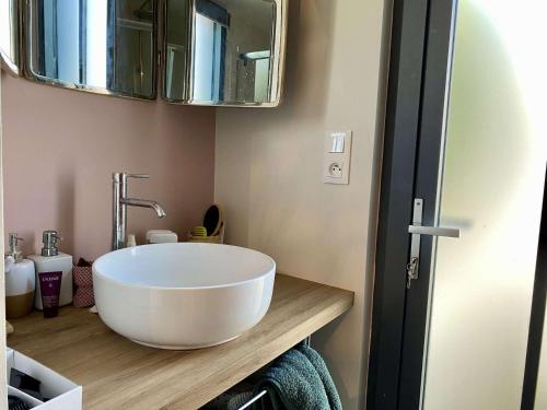 a bathroom with a large white bowl sink on a counter at Youyou Saint Gilles Croix de Vie in Les Bussolleries