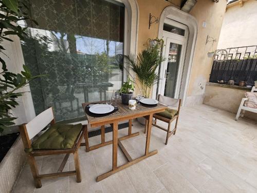 a wooden table and chairs on a patio at Villa Joy Verona - Junior Suite in Verona