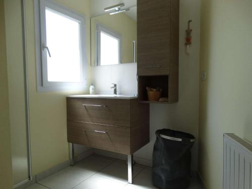 une salle de bain avec un lavabo et un miroir dans l'établissement Maison Saint Gilles Croix de Vie - L'Embellie, à Saint-Gilles-Croix-de-Vie
