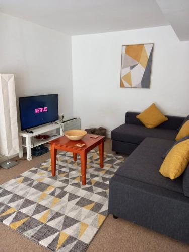 a living room with a couch and a coffee table at The Hanham Retreat in Bristol
