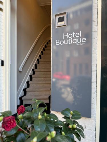 a sign on the side of a building with a staircase at Boutique Hotel By Atelier in Nijmegen
