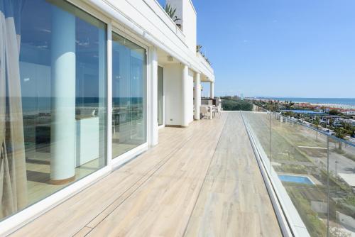 a balcony of a building with a view of the ocean at Golden Luxe - Panoramic Penthouse Rooftop whit Pool in Lido di Camaiore