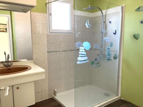 a bathroom with a glass shower with a sink at La Bussolerie de la mer - Saint Hilaire de Riez in Saint-Hilaire-de-Riez