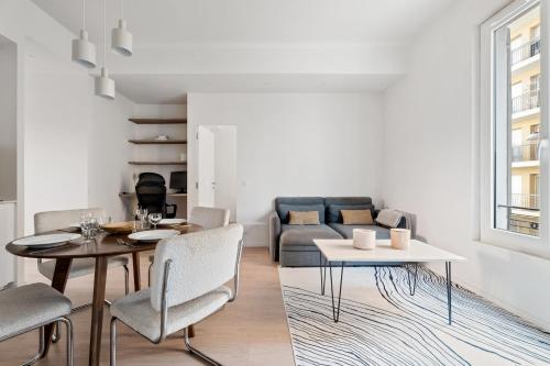 un salon avec une table, des chaises et un canapé dans l'établissement Appartement Ostave - Welkeys, à Nice