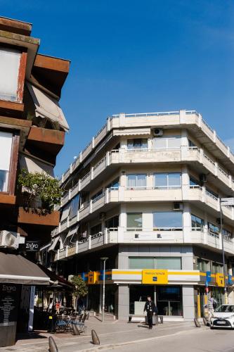 a tall white building on a city street at Vivian's Central Loft in Ioannina