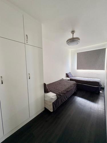 a small bedroom with a bed and a cabinet at 92 Camarque - 3 Bedroom Apartment With Amazing Sea Views In Umdloti in Umdloti