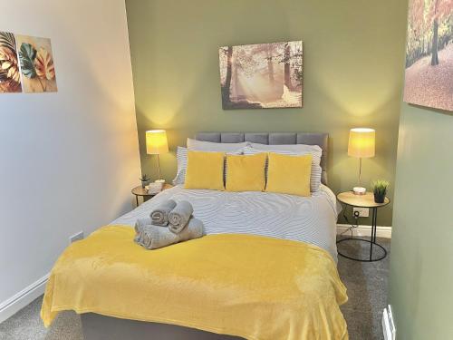 a bedroom with a bed with a stuffed animal on it at Ideal 3 bed pay-as-you-stay home in Wigan sleeps 6 in Wigan