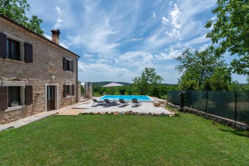 an external view of a house with a swimming pool at Holiday House with Private Pool Villa Ladybug in Milotski Breg