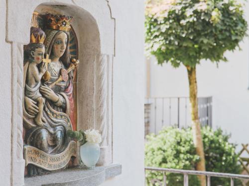 a statue of two women on the side of a building at Hotel Magdalena Mayrhofen in Mayrhofen