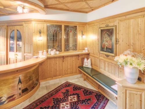 a large room with wooden paneling and a vase with flowers at Hotel Magdalena Mayrhofen in Mayrhofen
