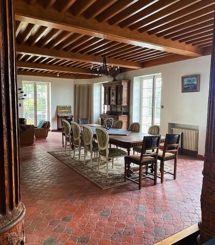 a dining room with a table and chairs at Château Philip in Saint-Genest-Lerpt