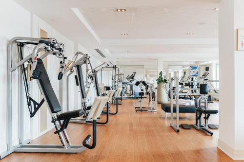a gym with treadmills and elliptical machines at Hotel Nassauer Hof in Wiesbaden